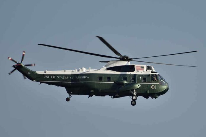 shutterstock_717006310 Green and white helicopter in flight