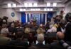 Taxpayer-Funded Trump Ad Sparks Legal Fire Press secretary at podium addressing reporters in briefing room