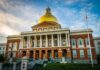 Sanctuary City Offers Migrant Only Program On Taxpayers Dime Massachusetts State House with golden dome and columns