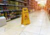 Injury Law Firms SCREWING People Out Of Millions! yellow wet floor sign in supermarket aisle