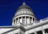 GOP Rep VINDICATED – 3 Charged in Sex Assault Case Capitol building dome with columns against a deep blue sky