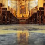 Livestream Mass Turns Deadly – Crucifix Collapses! Church interior with wooden pews facing ornate altar