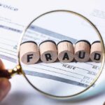 DEM CORRUPTION SCANDAL: Husband of Candidate ARRESTED! Magnifying glass highlighting wooden blocks spelling fraud on an invoice