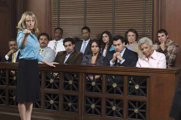 shutterstock_121503343-1 Attorney pointing toward the jury in a courtroom