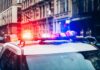 Police car with flashing lights in city street