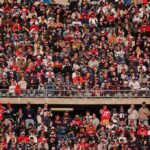 Homecoming Chaos – 11 GUNNED DOWN Outside Stadium Peter Keys in a large stadium crowd of football fans