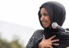 Ilhan Omar’s Father Was a Colonel to Brutal Somali Dictator Ilhan Omar speaking at a microphone with hand on chest