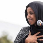 Ilhan Omar’s Father Was a Colonel to Brutal Somali Dictator Ilhan Omar speaking at a microphone with hand on chest