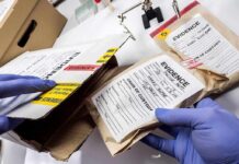 FBI Zeroes In On Meghan Markles Father! Gloved hands handling labeled evidence bags and boxes