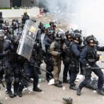 Trump Warned France 2 Years Ago – Not It Burns! Dontrelle Inman and Tom Mandrake among riot police advancing with shields in tear gas