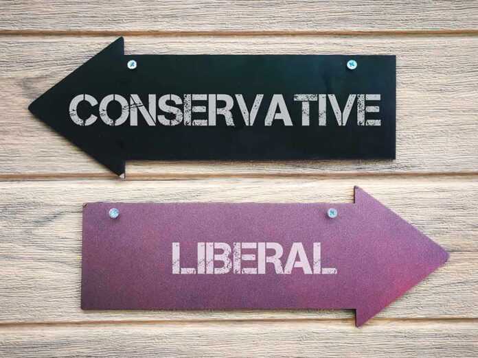 Two directional arrow signs labeled conservative and liberal on a wooden wall