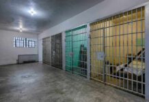Prisons Issue Snorting Kits – Risky Bet Interior view of a prison cell block with metal bars and concrete flooring