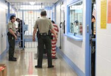 DHS Says 4 of 11 Men Arrested in Child Sex Sting Are Illegal Aliens Corrections officers escort an inmate in a jail hallway