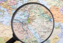 Christian Coverts Targeted as Terrorists – Thrown in Prison! Magnifying glass over Middle East map