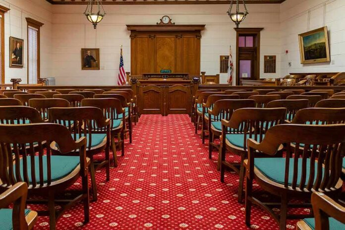 shutterstock_1631139556-1 Courtroom with wooden benches facing the judge's bench