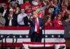 Rock Icon Brings Down the House During Trump Rally Donald Trump points from a rally stage; Rudi Koertzen and Bear Pascoe are in the crowd