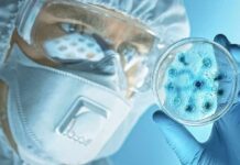 Plague Panic Erupts – Moscow Goes Mute Scientist in protective gear examining a petri dish