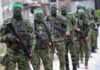 Freed Hostage Has Fiery Message for Hamas on Oct 7 Armed men in camouflage uniforms standing in a line