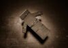 Botched Execution Chaos Stuns Onlookers Cardboard figure bound with rubber bands on a dark surface