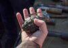 Estate Sale Horror: Live Grenades in the Box Hand holding a vintage hand grenade