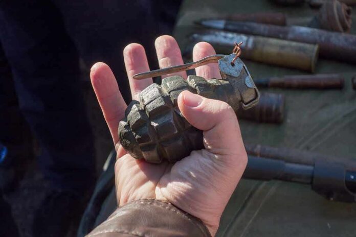 shutterstock_1780732496 Hand holding a vintage hand grenade