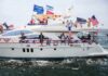Stephen Paea on a decorated yacht with American flags during a boat parade