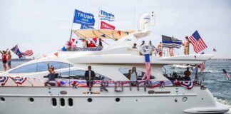 Stephen Paea on a decorated yacht with American flags during a boat parade