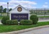 Judge Goes Berserk After Trump CHOPPED Over 500 Trees at Golf Course Entrance sign at a golf course with manicured shrubs