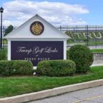 Judge Goes Berserk After Trump CHOPPED Over 500 Trees at Golf Course Entrance sign at a golf course with manicured shrubs