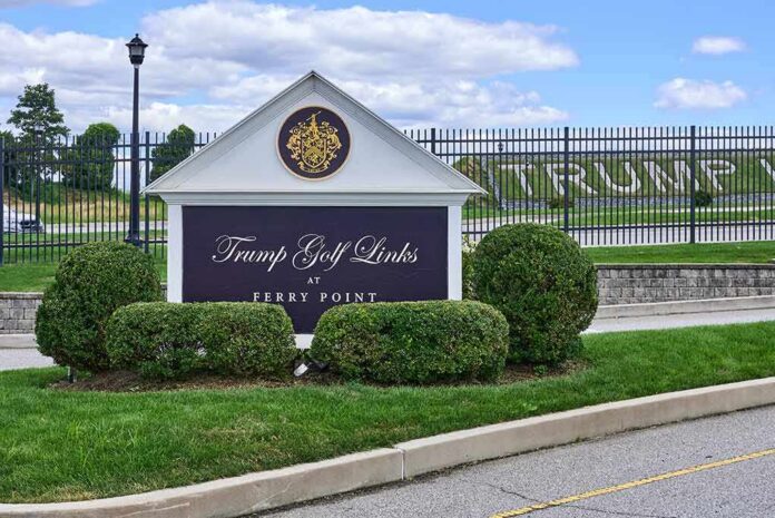 Entrance sign at a golf course with manicured shrubs
