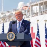 Trump Calls for Mandatory Prison Sentences for Crooked Politicians Donald Trump speaking at a podium with American flags and a ship in the background
