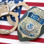 Man Arrested for Posing as ICE Agent at Polling Station ICE officer badge and handcuffs on an American flag
