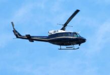Runway Scare: Second Lady Stumbles With Newborn Helicopter flying against a blue sky