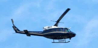 Helicopter flying against a blue sky