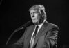 DNC Sues Trump Alleging Illegal Propaganda Campaign Donald Trump speaking at a microphone in a black-and-white photo