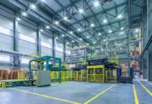 1,341 Jobs VANISH Minutes Before Trump Rally Automated factory floor with industrial machinery and safety railings