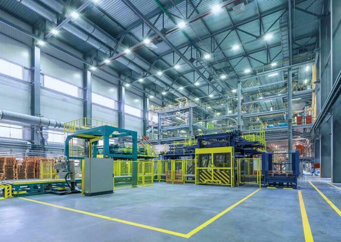 Automated factory floor with industrial machinery and safety railings